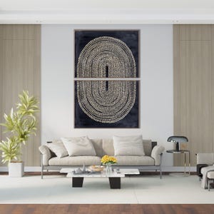 May include: Two-piece abstract wall art featuring a dark blue background with a cream-colored dotted design. The artwork is displayed above a light-colored sofa in a modern living room setting. The room includes a white rug, a coffee table, and a potted plant.
