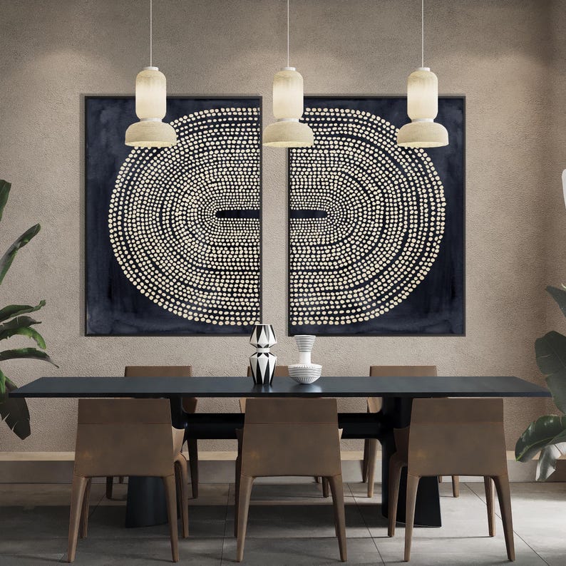 May include: A modern dining room featuring a long, dark table with six chairs. Two large abstract paintings with white dot patterns hang on the wall. Three pendant lights hang above the table, and decorative vases are on the table.