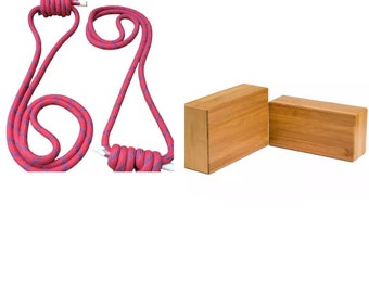 May include: Two red and blue yoga ropes and two wooden yoga blocks. The ropes are tied in a knot at the top. The blocks are made of natural bamboo.