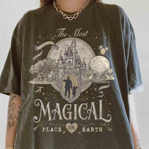 May include: A white ceramic mug with a black handle and the text "But First, Coffee" in a bold, black font. The mug is set against a blurred background, suggesting a cozy setting.