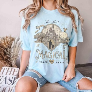 May include: A white ceramic mug with a black handle and the text "But First, Coffee" in a handwritten style. The mug is likely for hot beverages and has a glossy finish.