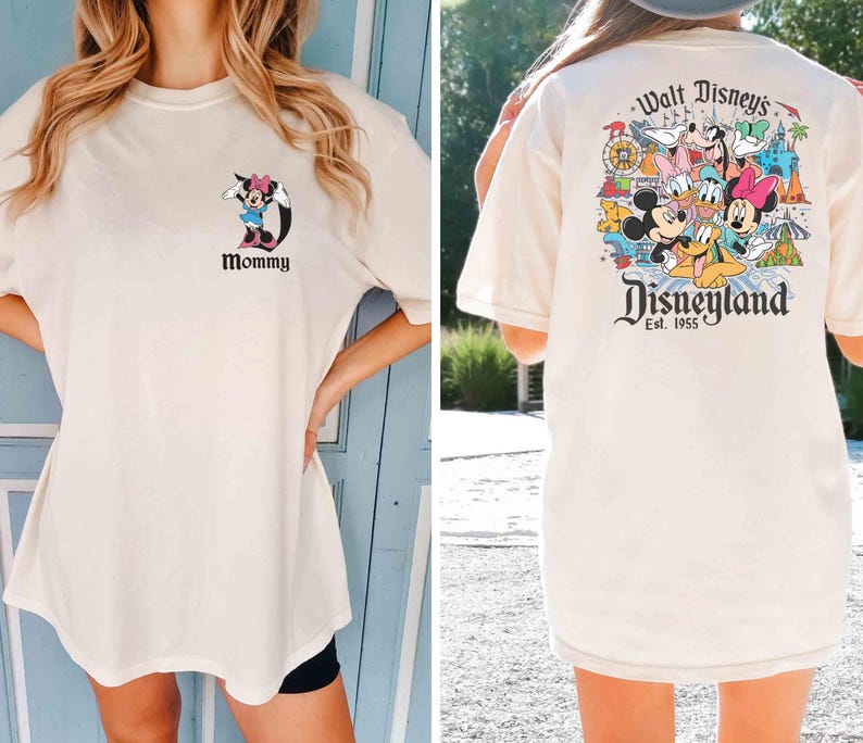 以下が含まれることがあります： ディズニーをテーマにした白いTシャツ2枚。1枚のシャツの前面には、ミニーマウスの漫画の画像と「Mommy」という文字が描かれています。もう1枚のシャツの背面には、ミッキーマウス、ミニーマウス、ドナルドダック、グーフィー、プルート、その他のディズニーキャラクターのカラフルな画像と「Walt Disney's Disneyland Est. 1955」という文字が描かれています。