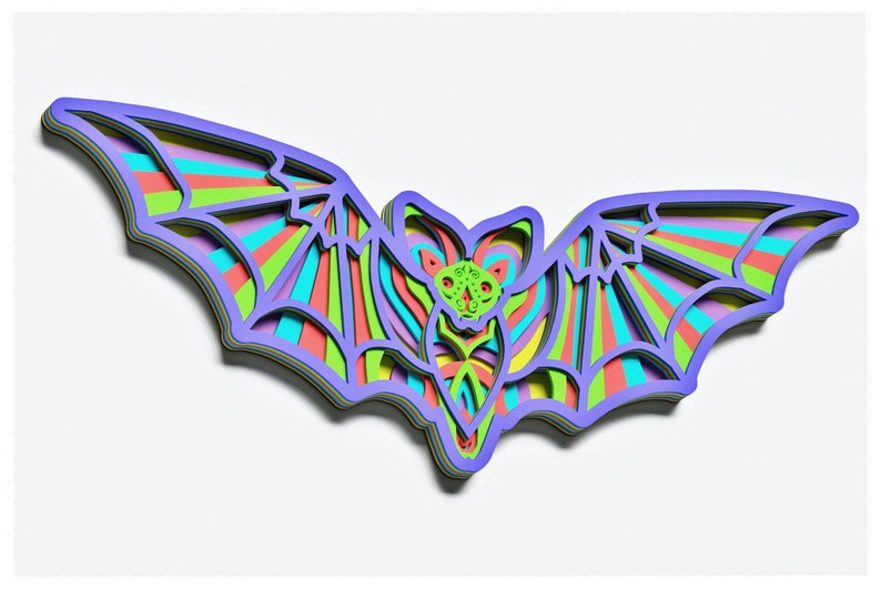 May include: A colourful layered paper bat with a rainbow striped design. The bat is cut out of paper and has a 3D effect.