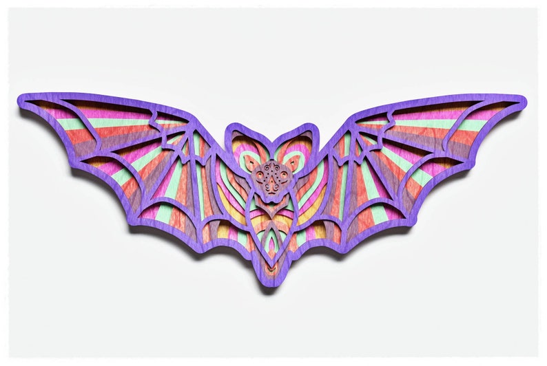 May include: A wooden bat cutout with a colourful striped pattern in shades of purple, pink, orange, yellow, and green. The bat is intricately designed with a layered effect, creating a 3D look.