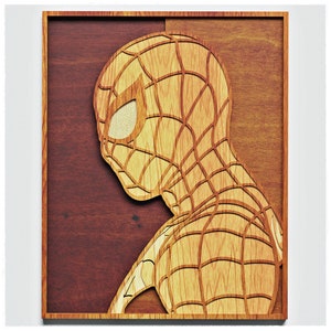 May include: A wooden wall art piece featuring a cutout of a red and black Spiderman character. The background is a dark brown wood.
