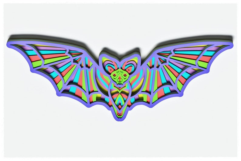 May include: A colourful paper bat with layered wings and a detailed face. The bat is made of paper and has a layered design with shades of green, blue, pink, and purple.
