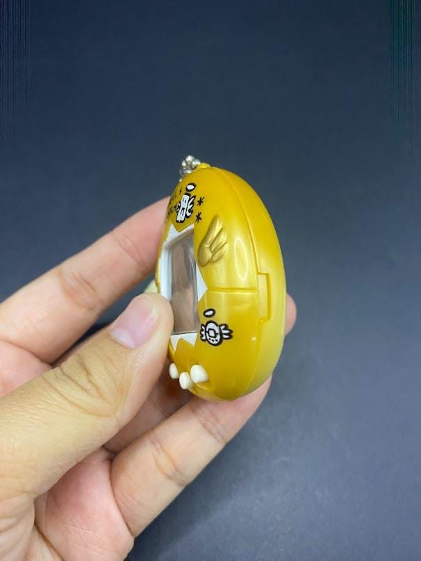 SKU B663P6842 TA8 | Vintage Tamagotchi Angel Yellow With Gold