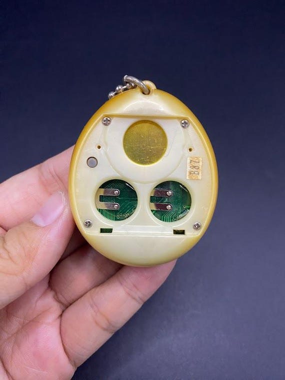 SKU B663P6842 TA8 | Vintage Tamagotchi Angel Yellow With Gold