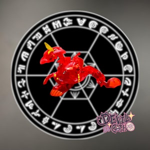 May include: A red and yellow plastic toy dragon with a black background featuring a circle with white symbols. The toy dragon is in a pose with its wings spread out.