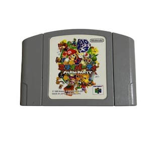 May include: A gray Nintendo 64 video game cartridge for Mario Party. The label features colorful illustrations of Mario, Luigi, Donkey Kong, and other characters, along with the game title in Japanese and English, and the Nintendo 64 logo.