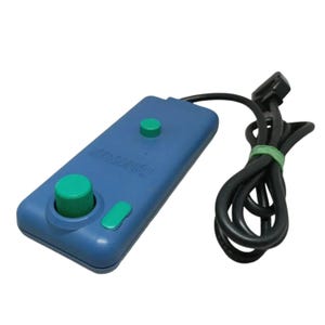 May include: A blue rectangular video game controller featuring a prominent green circular joystick, a small green button, and a secondary green button. The device includes a black wired cable with a connector, coiled and secured with a green tie.