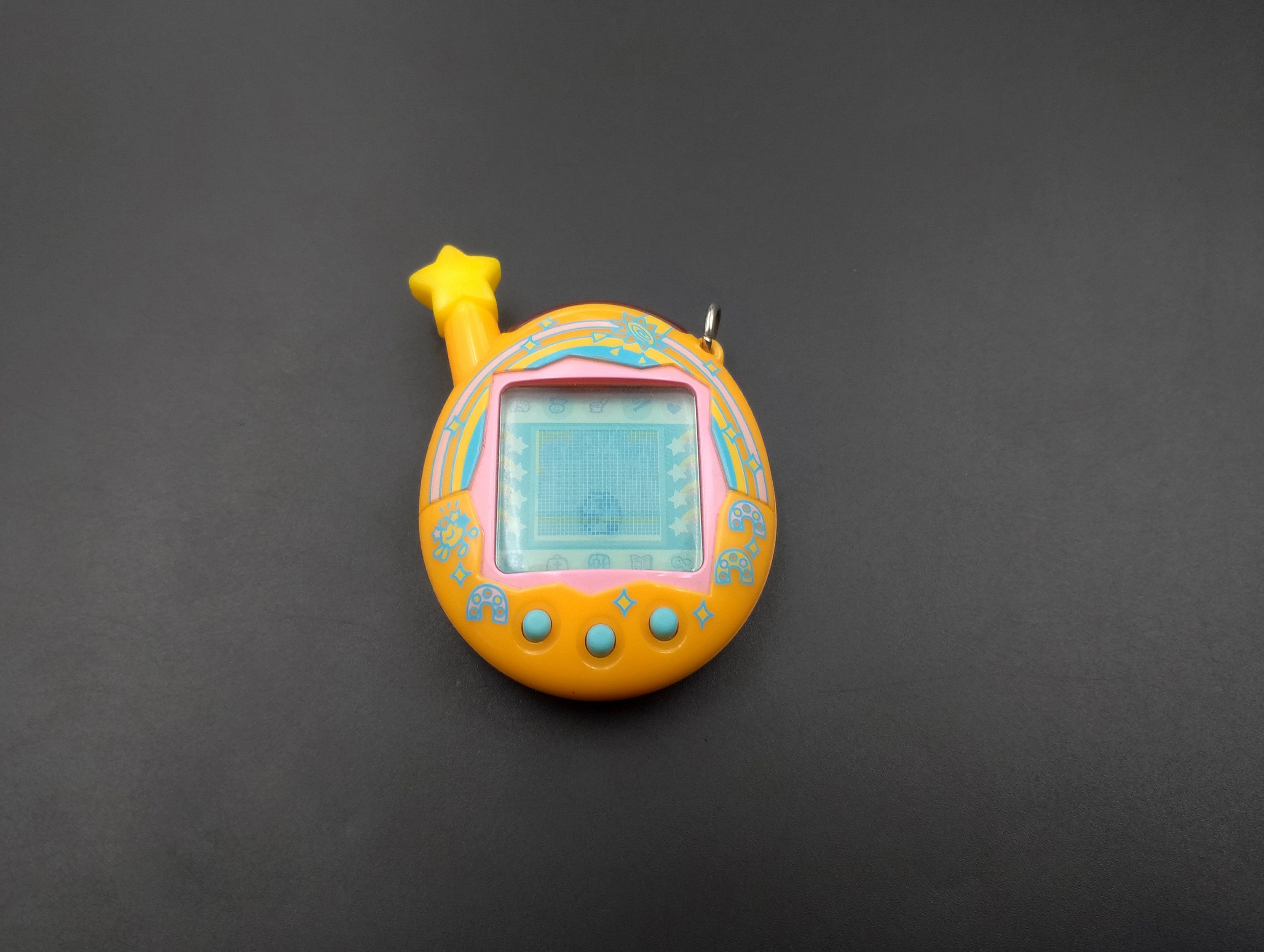 SKU TB F56 | Tamagotchi Connection V4.5 Orange Yellow Good SKU TB F56 | Tamagotchi Connection V4.5 Orange Yellow Good