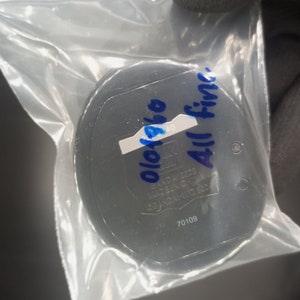 May include: A black round container with a white label that says "010140" and blue writing that says "All Fine". The container has a number "70109" printed on it.