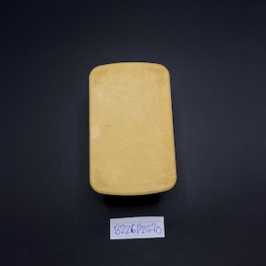 May include: A rectangular, light yellow box with rounded corners and floral corner designs. The box has a textured surface and a label with the text "B226P2670" is below it.