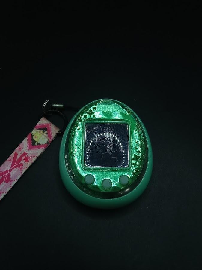 SKU B697P7262 | Tamagotchi Idl Green Pet Game Bandai Tested Japan