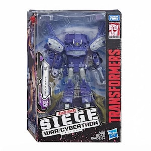 May include: A purple and silver Transformers Siege War for Cybertron Decepticon Shockwave action figure inside its original rectangular cardboard packaging. The box features the Transformers logo, the text Siege War for Cybertron, and Takara Tomy.
