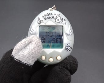 SKU B913P11653TA8 | Bandai Tamagotchi Angel Gotch Silver - Etsy Israel
