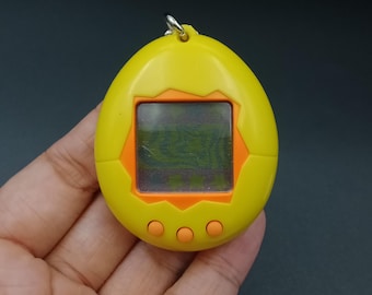 SKU YU145 | Tamagotchi P1/P2 Yellow Orange Bandai Japanese Toy