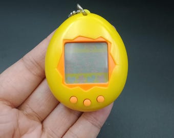 SKU YU117 | Tamagotchi P1/P2 Yellow Orange Bandai Japanese Toy