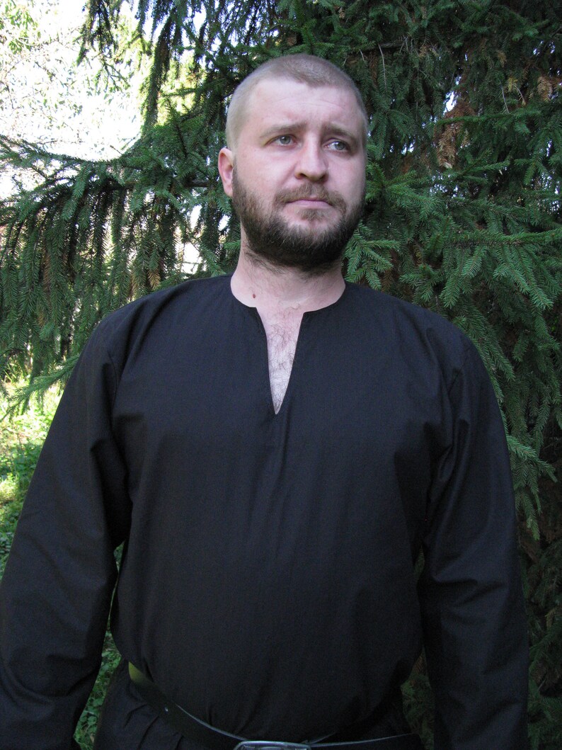 May include: A black long-sleeved shirt with a V-neck and a simple design. The shirt is made of a soft, comfortable fabric.