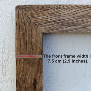 May include: Close-up of a rustic wooden picture frame corner. The front frame width is 2.9 inches. The wood has a natural, weathered appearance with visible grain and texture, showcasing a warm, brown color.