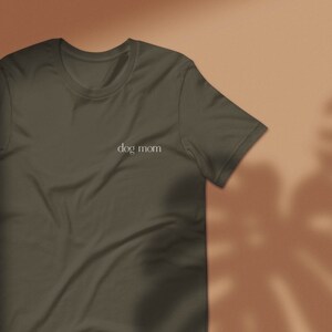 May include: A dark green t-shirt with the text "dog mom" printed on the front.
