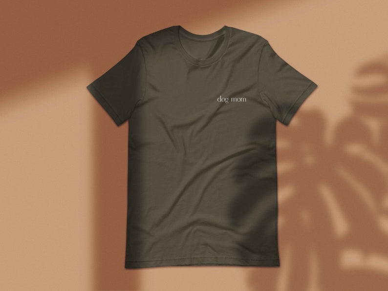 May include: A dark green t-shirt with the text "dog mom" printed on the front.