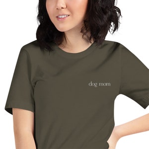 May include: A dark green t-shirt with the text "dog mom" in white lettering.