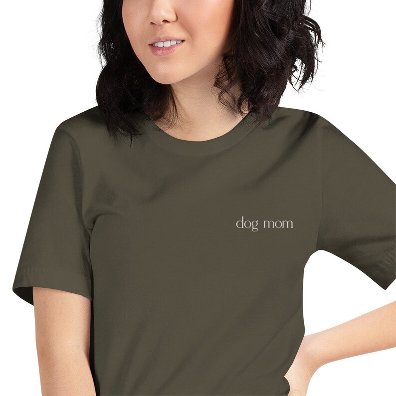 May include: A dark green t-shirt with the text "dog mom" in white lettering.