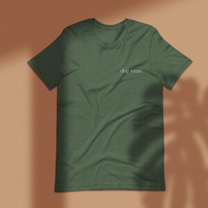 May include: A dark green t-shirt with the text "dog mom" printed in white on the front.