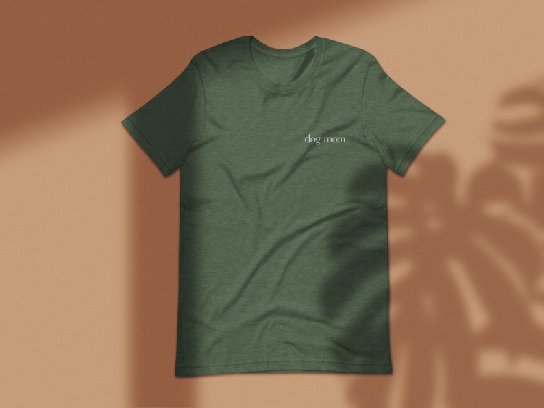 May include: A dark green t-shirt with the text "dog mom" printed in white on the front.