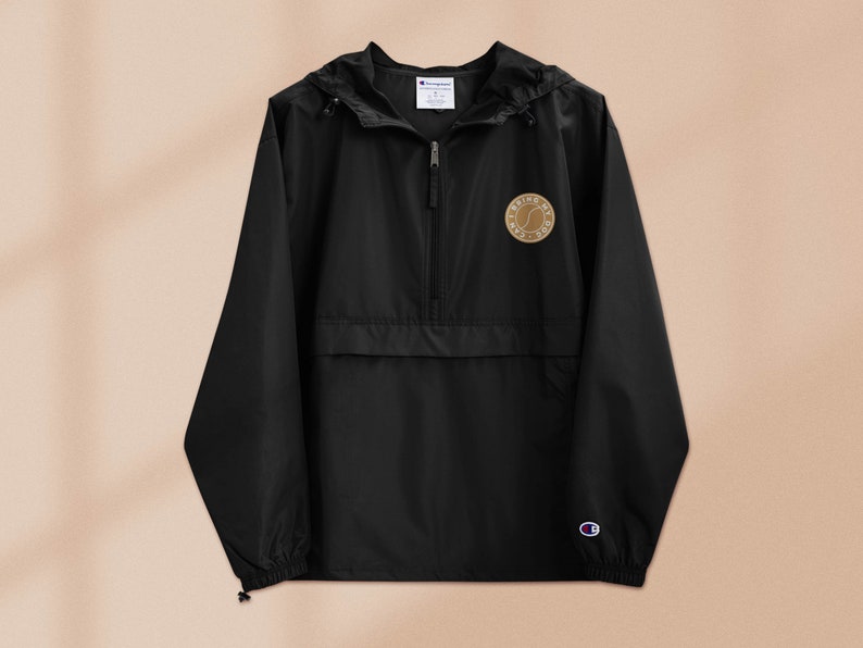 May include: Black windbreaker jacket with a zipper closure and a small brown patch on the left chest that says "Bring My Dog".