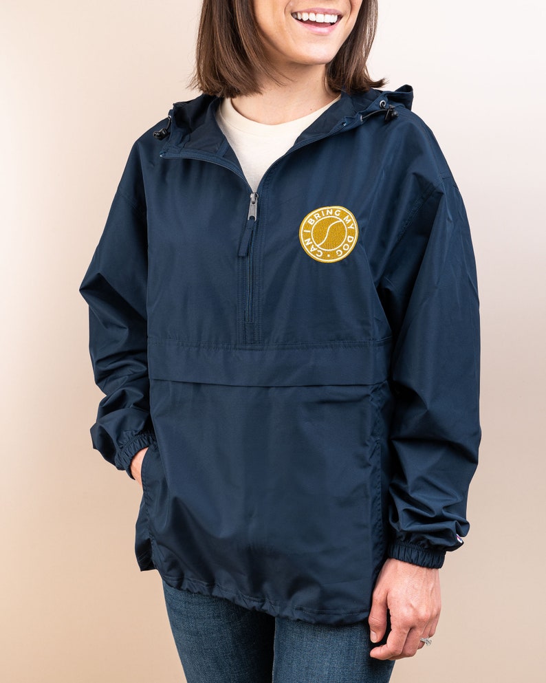 May include: A navy blue hooded jacket with a zipper closure and a gold embroidered patch that says "I can bring my dog".