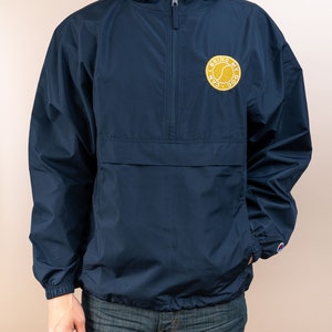 May include: A navy blue windbreaker jacket with a zipper closure and a hood. The jacket has a yellow embroidered patch on the left chest that says "I Can Bring My Dog".