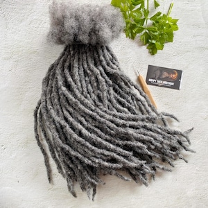 May include: A bundle of gray dreadlocks hair extensions. The hair is long and thick, and it is perfect for adding length and volume to your hair.