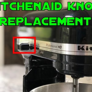 Peut inclure: Gros plan d'un robot culinaire KitchenAid noir avec le texte "KITCHENAID KNOB REPLACEMENT" en vert. L'image met en évidence la zone du bouton avec un cadre rouge. Le robot est étiqueté "Professional HD".