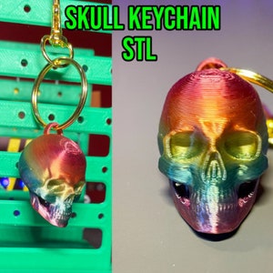 May include: A rainbow colored 3D printed skull keychain with a gold metal ring. The keychain is hanging from a green pegboard.