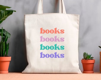 May include: A white canvas tote bag with the word "books" repeated four times in different colours: orange, pink, teal, and purple.