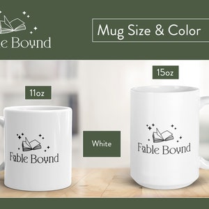 May include: Two white ceramic mugs with a black and white illustration of a book with stars. The smaller mug is 11 oz and the larger mug is 15 oz. The text "Fable Bound" is printed on both mugs.
