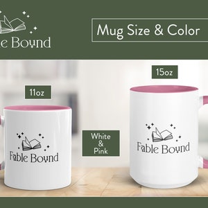 May include: Two white ceramic mugs with pink accents. The mugs feature a black and white illustration of an open book with stars. The text "Fable Bound" is printed on the mugs. The mugs are available in 11oz and 15oz sizes.