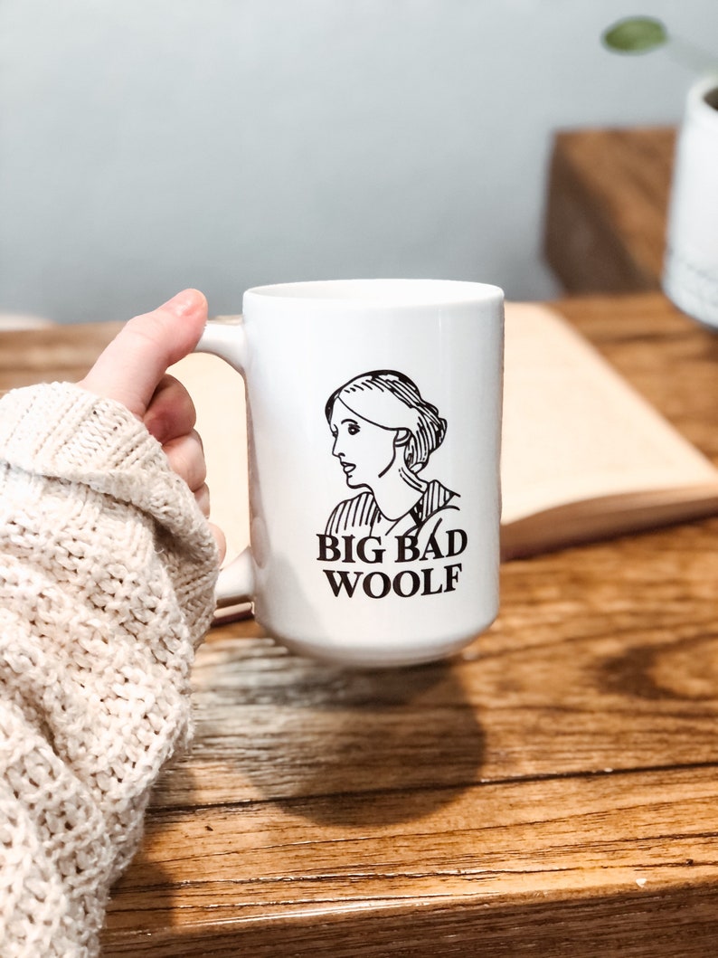 May include: White ceramic mug with a black and white illustration of a woman and the text "BIG BAD WOOLF".