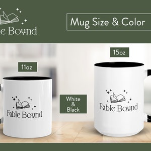May include: Two white ceramic mugs with black rims. The mugs feature a black and white illustration of an open book with stars. The text "Fable Bound" is printed on the mugs. The mugs are available in 11oz and 15oz sizes.