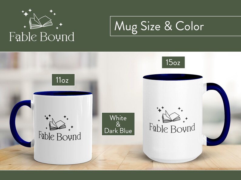 May include: Two white ceramic mugs with a dark blue rim and handle. The mugs feature a black and white illustration of an open book with stars. The text "Fable Bound" is printed on the mugs. The mugs are available in 11oz and 15oz sizes.