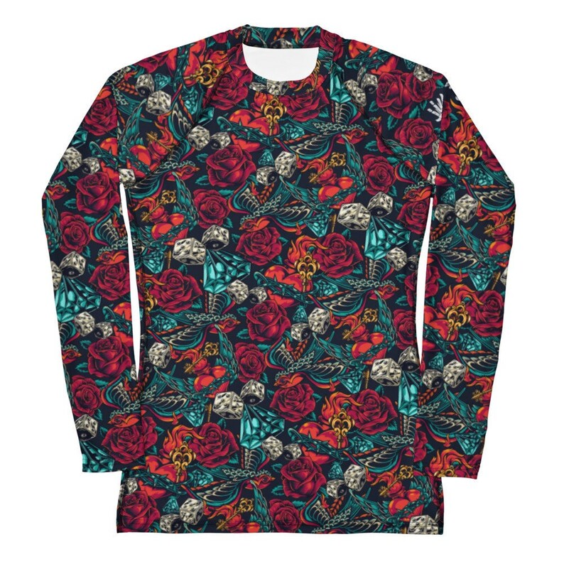 May include: A long-sleeved shirt with a dark blue background and a repeating pattern of red roses, dice, and jewels. The pattern is in a vintage style.