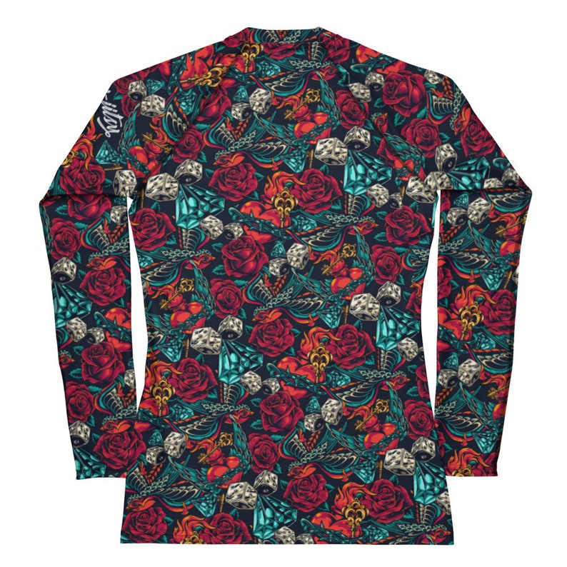 May include: A long-sleeved shirt with a dark blue background and a repeating pattern of red roses, dice, and keys. The pattern is in a vintage style.