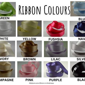 May include: A color chart of ribbon rolls in various colors, including green, blue, white, yellow, fuchsia, navy, ivory, brown, lilac, silver, champagne, pink, purple, and black. The text "RIBBON COLOURS" is at the top. Ribbons are 25mm in thickness.