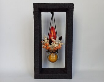 Boho Home Decor - Glass jars with dried flowers and beeswax on the wooden stand wrapped with black cotton rope