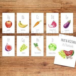 May include: A set of educational flashcards featuring watercolor illustrations of fruits and vegetables labeled from A to I, including an apple, bananas, carrot, dragonfruit, eggplant, fig, grapes, horseradish, and iceberg lettuce.