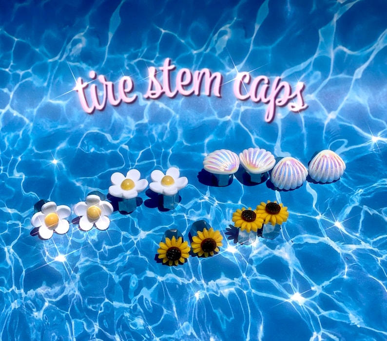 May include: Assortment of tire stem caps featuring white daisies, yellow sunflowers, and iridescent seashells. "tire stem caps" is written in pink letters across the top of the image.