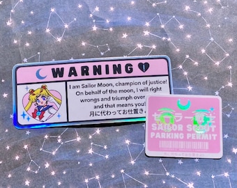 May include: Two pink and white holographic stickers featuring Sailor Moon. The first sticker has a warning sign with Sailor Moon's image and the text "I am Sailor Moon, champion of justice! On behalf of the moon, I will right wrongs and triumph over and that means you! 月に代わってお仕置き。". The second sticker has the text "セーラー戦士 SAILOR SCOUT PARKING PERMIT".